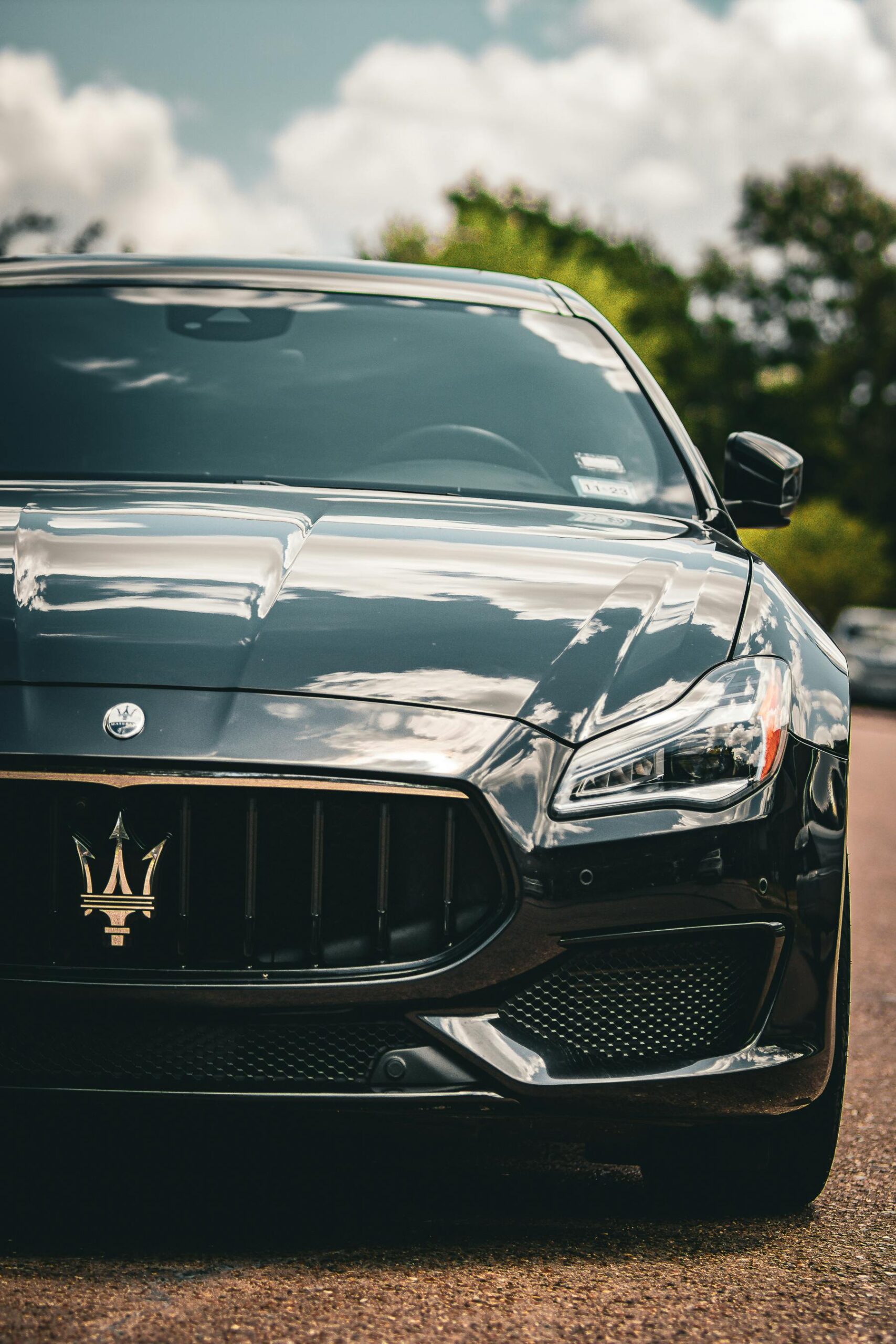 Elegant Maserati Quattroporte showcasing luxury car design on a scenic road.